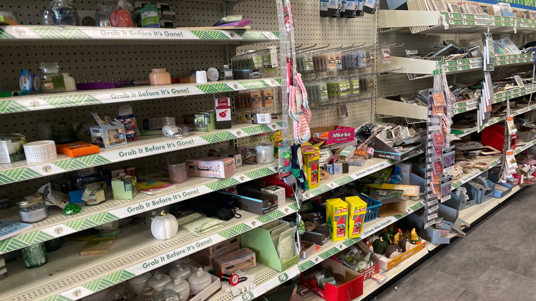 A Dollar Tree store aisle with indoor décor items on the shelves.