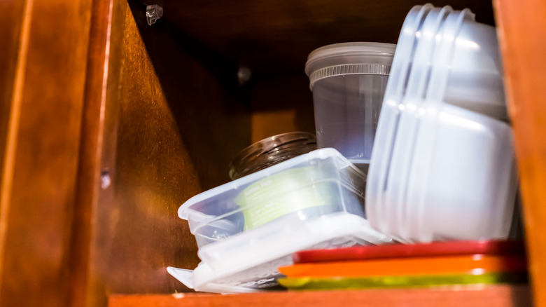 cluttered shelf in kitchen cabinet