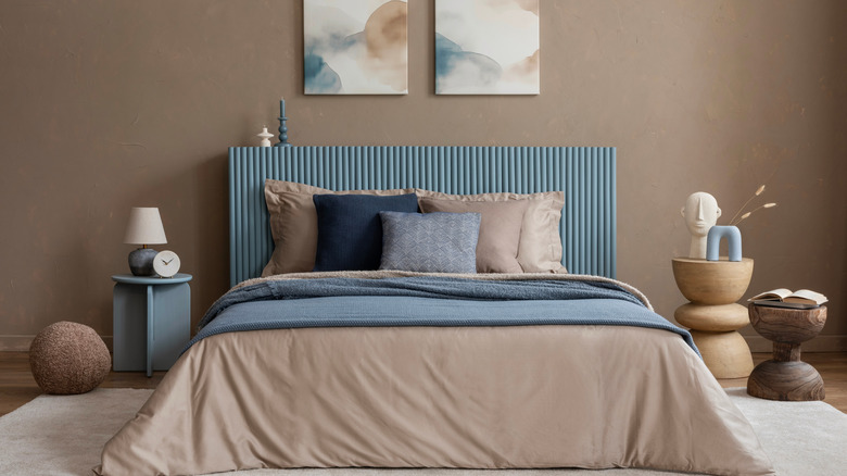 A fully made bed with a mix of colors and patterns