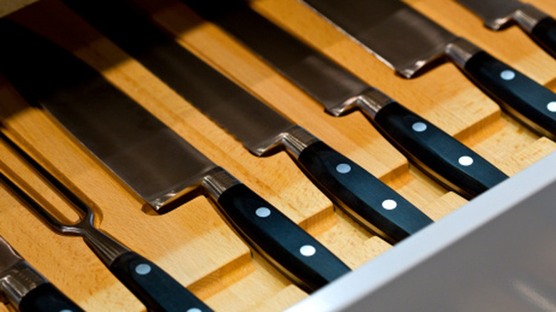 Knives laying down in a drawer