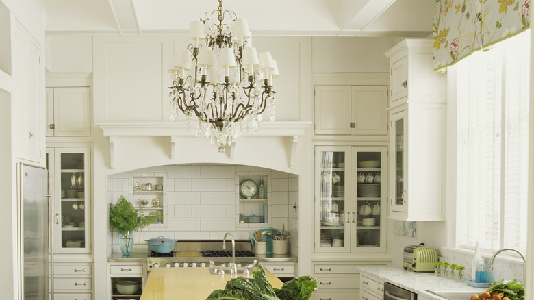 Ornate metal chandelier in white farmhouse kitchen