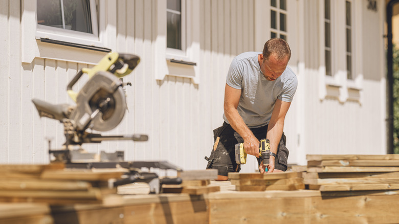 Man building a backyard deck