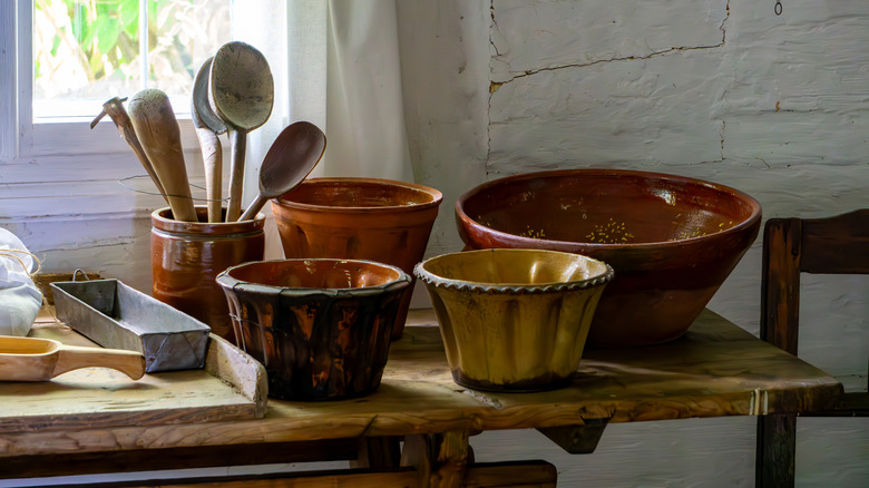Handmade bowls on a wooden table with wooden spoons