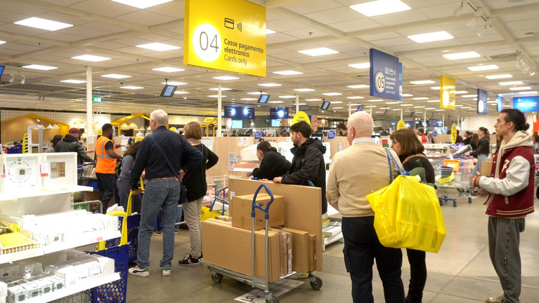 Shoppers waiting in line to check out at an IKEA store