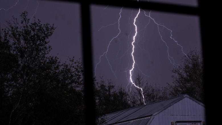Lightning strike seen from a home's window during a storm and power outage