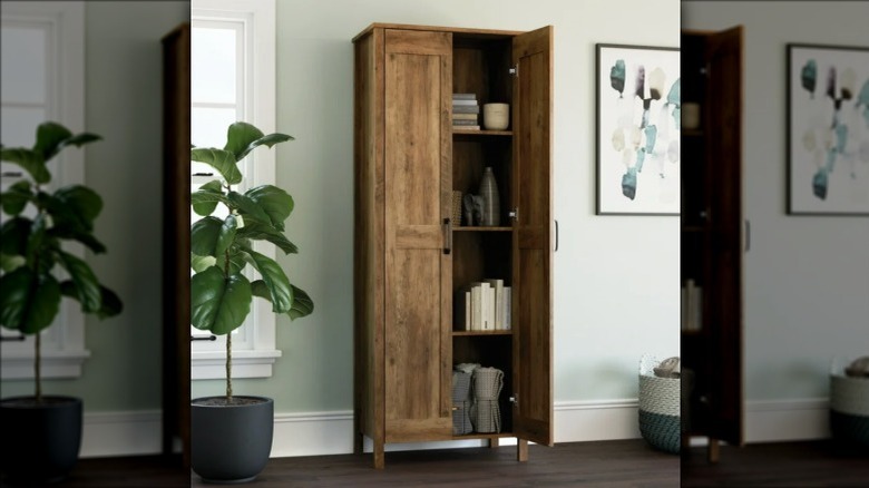 A wood-look tall storage cabinet in a living room