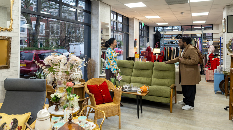 Shoppers inspecting the furniture in a thrift store