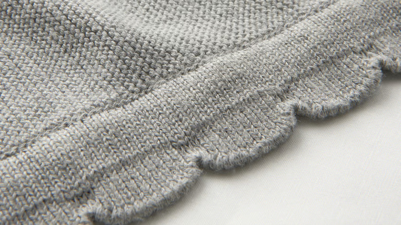 A closeup of the gray knitted LEN baby blanket
