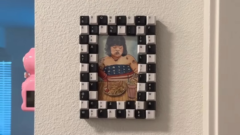 Drawing in computer keyboard picture frame hung on wall
