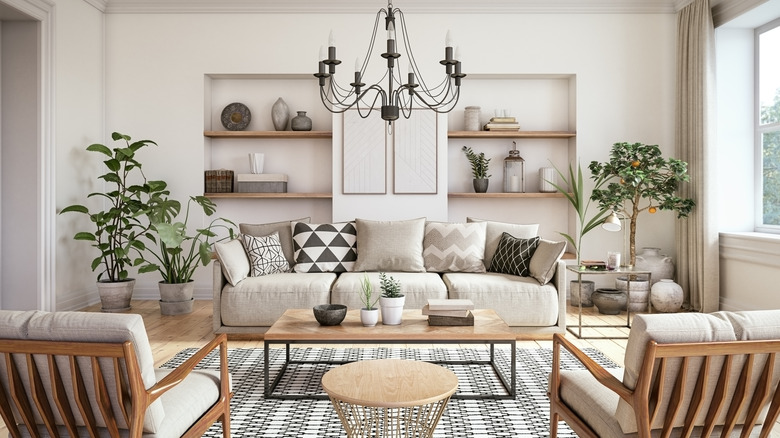 A neutral-painted living room with layered textures, wood materials, and an iron chandelier