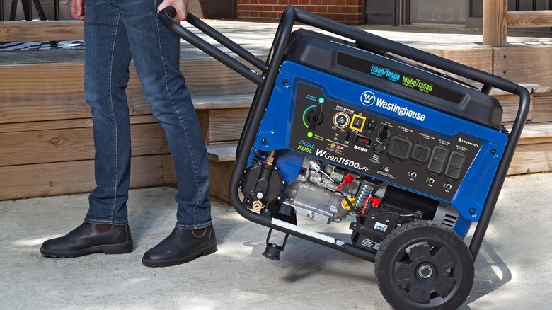 a man moving a Westinghouse 14500-Watt Portable Generator