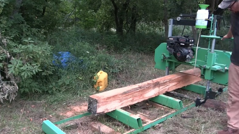 Cut log moving through a portable sawmill