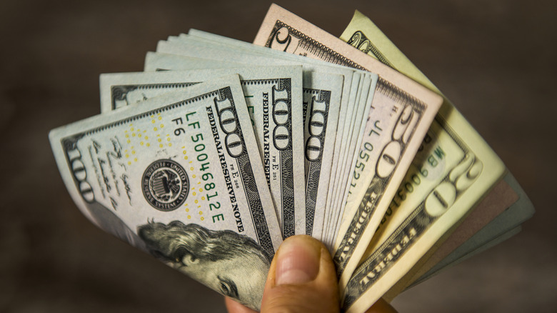 hand holding folded bills