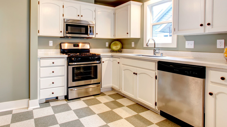 A kitchen with gray and white checkerboard floors.