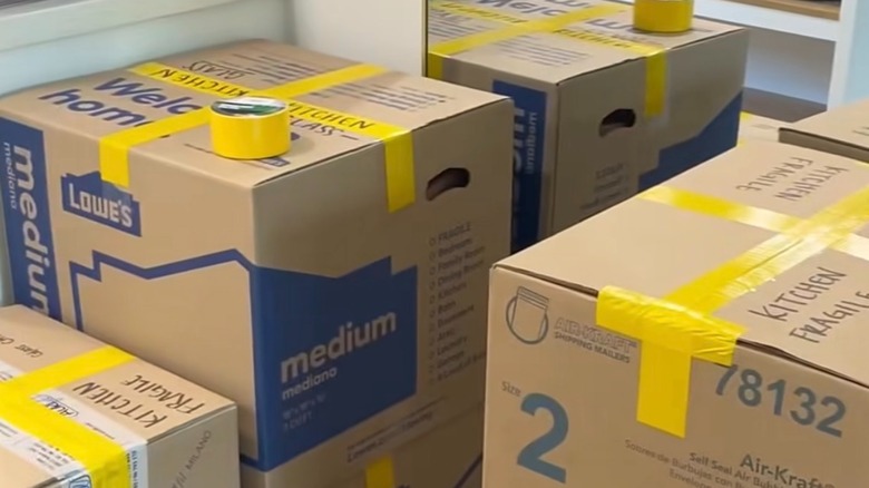 Colored duct tape labeling moving boxes