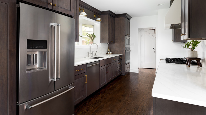 A kitchen with dark wood floors and cabinets.