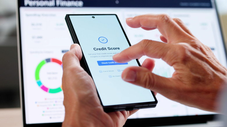 Person checking their credit score on a smartphone