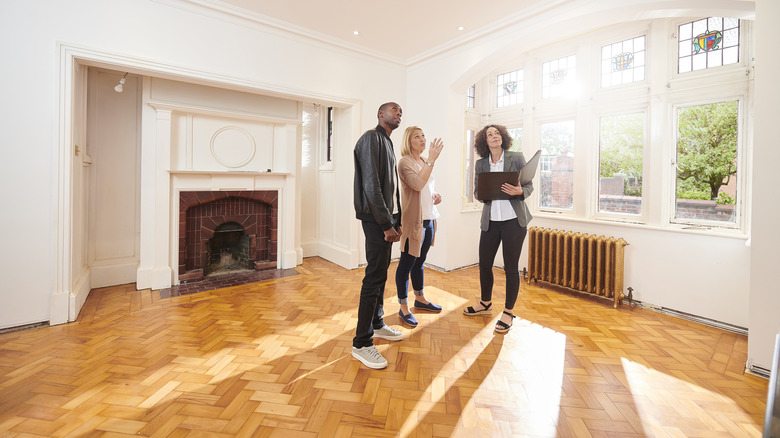 A couple is viewing a house with a real estate agent