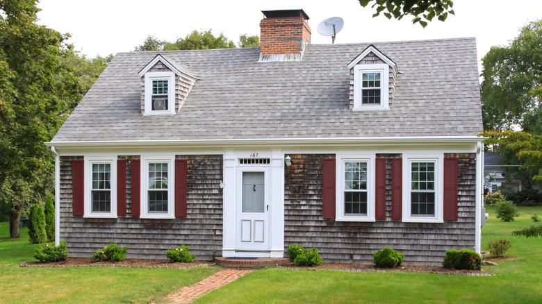 A Cape Cod-style of house with weathered shakes.