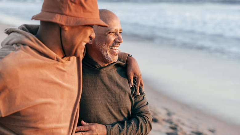 Mature couple looking happy at the beach.