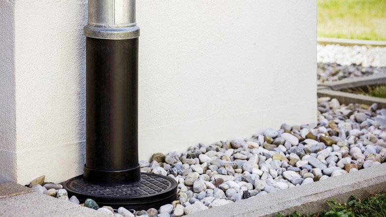 a French drain with a downspout that goes into a gravel bed
