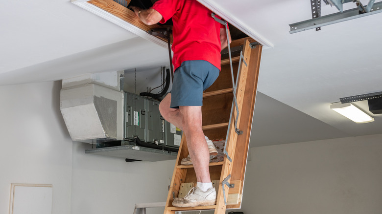 Man going into attic