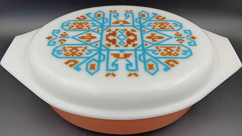 A rust, turquoise, and white Pyrex Navajo casserole dish with lid