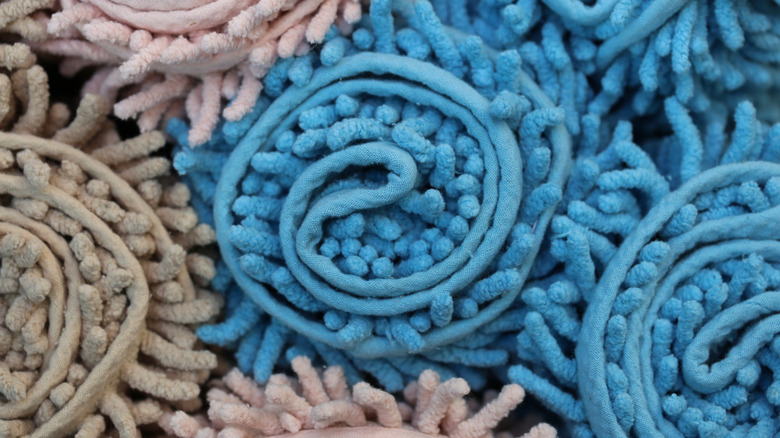 Colorful bath mats rolled up