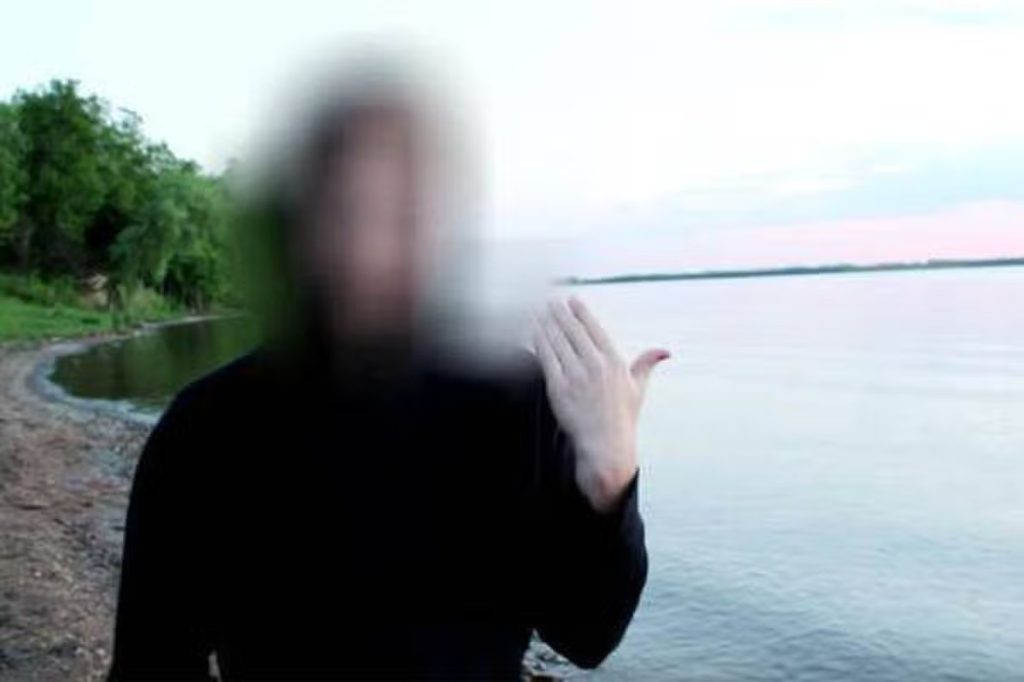 Masked man claiming to be a time traveller warns of climate disaster and criticises political divisions